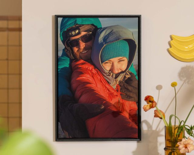 A framed photo of a couple hanging on a wall.
