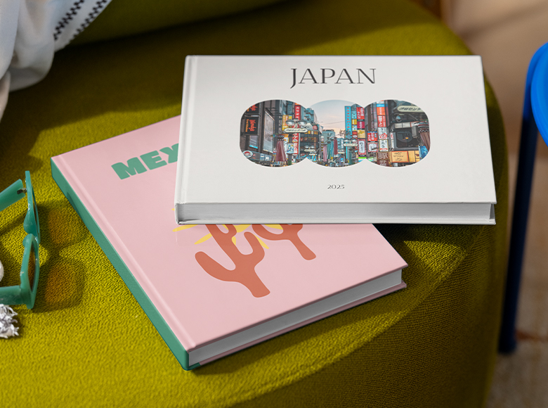 Two travel photo books lying on a chair