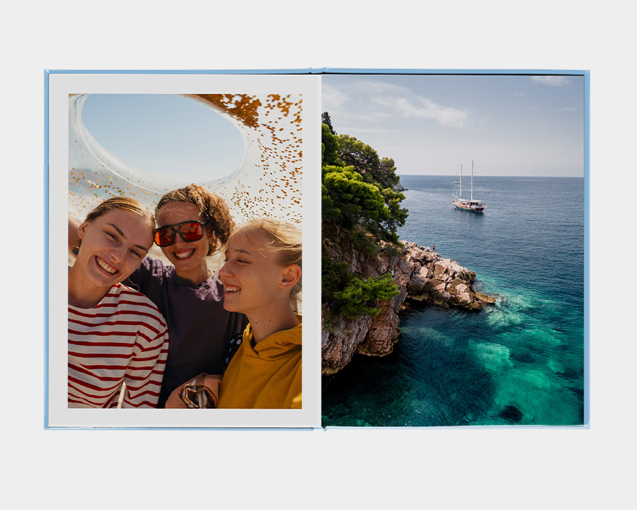 A large portrait photo book with an image of a person looking at a mountain lake