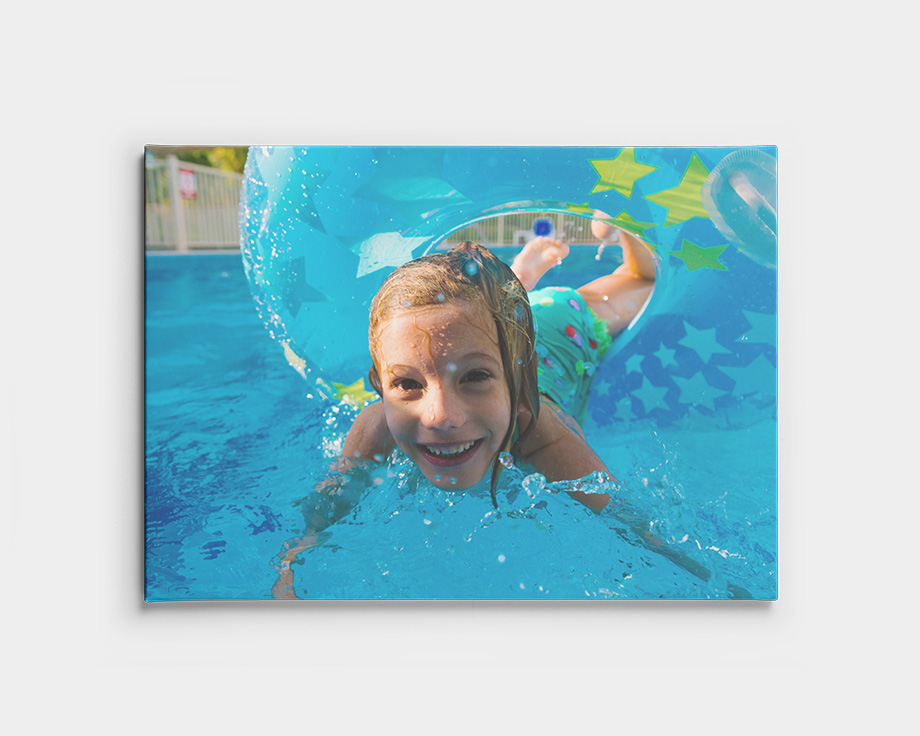 Canvas print of a child swimming underwater in a pool.