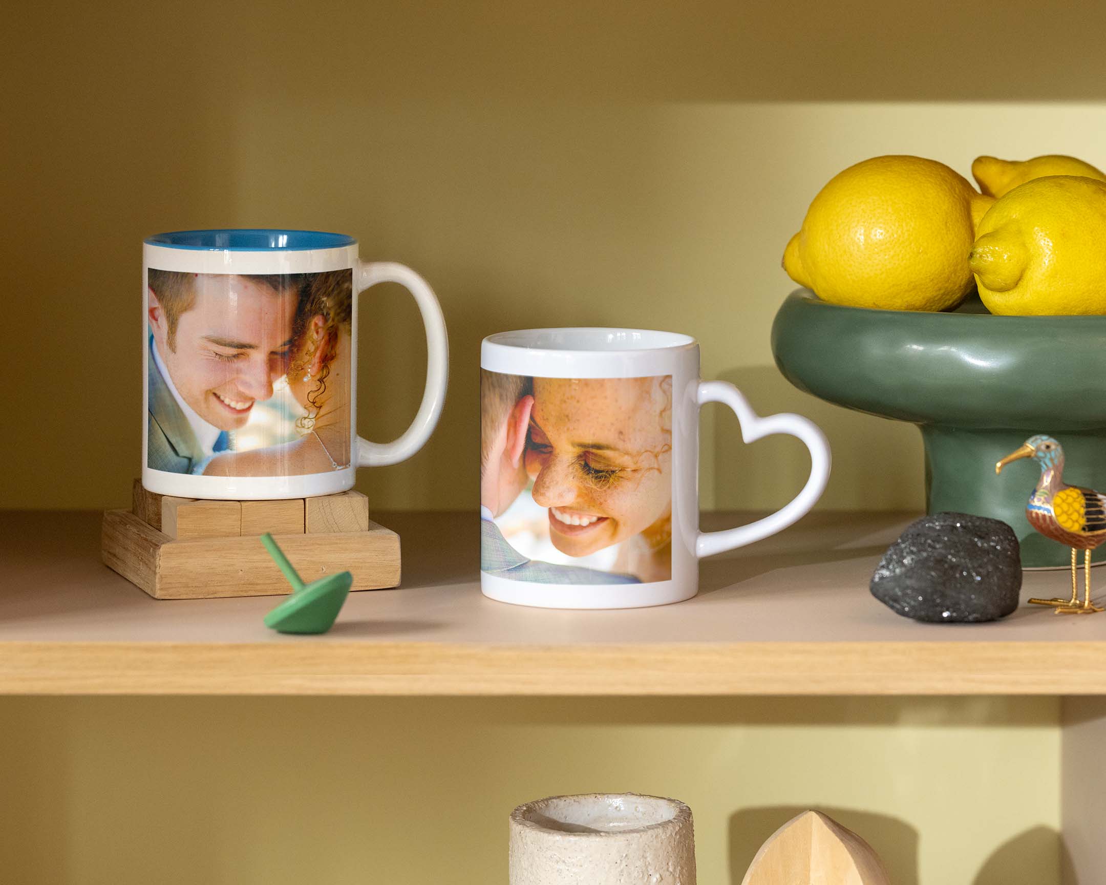 Two personalised mugs with wedding photos, one with a heart-shaped handle.