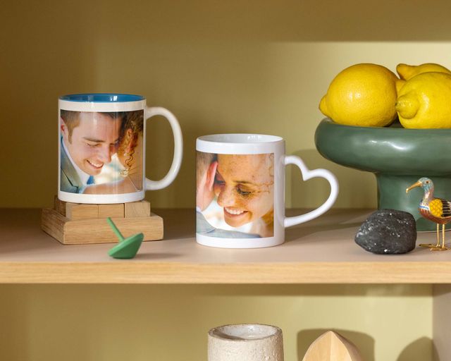 Two personalised mugs with wedding photos, one with a heart-shaped handle.